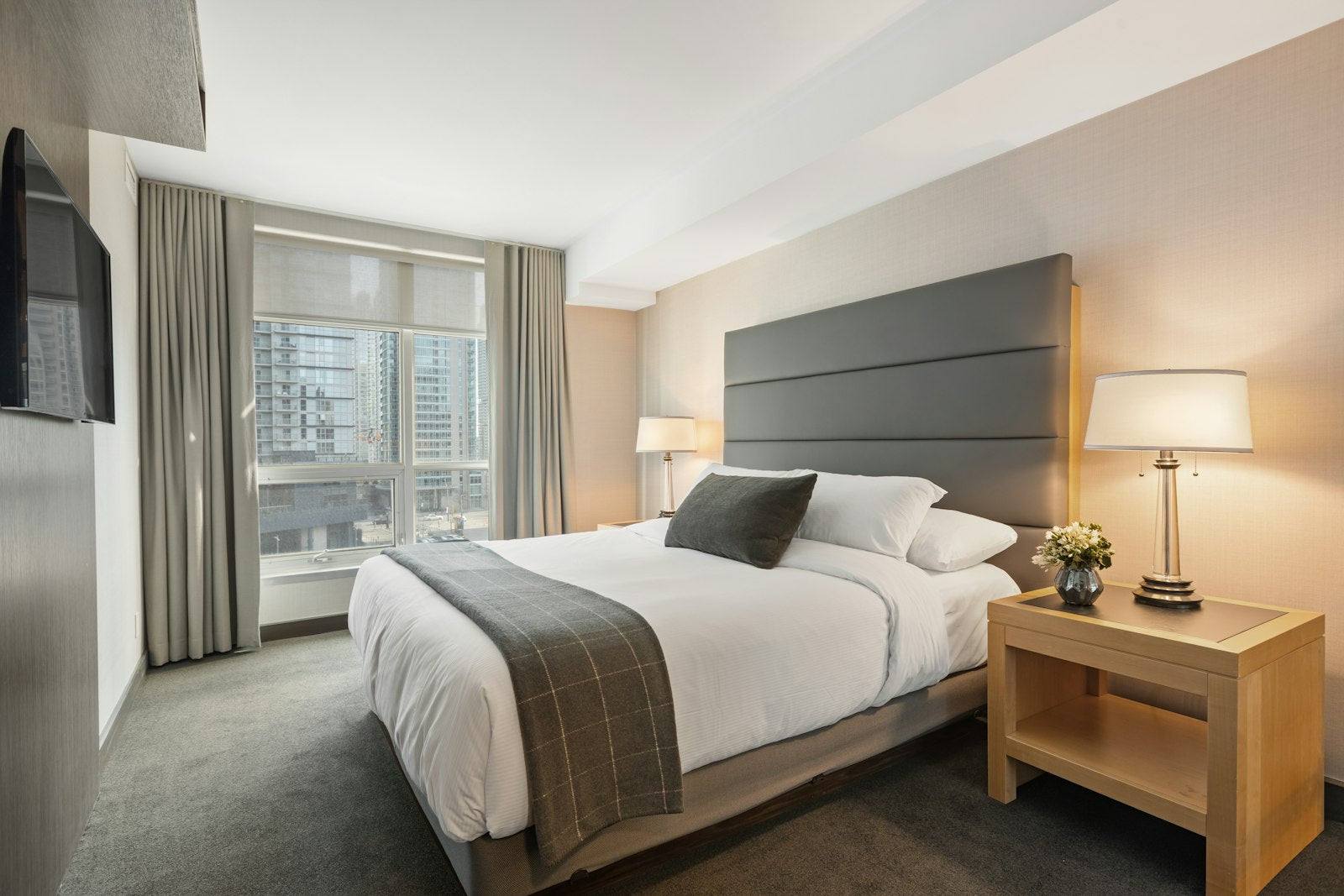 A bright, cozy bedroom with natural morning light streaming through an open window